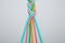 Braided colorful ropes on light grey background. Unity concept