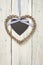 Braided heart with blackboard on a wooden background