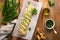 Braided wild garlic pesto brioche. Homemade fresh pull apart bread with wild garlic pesto on wooden board on wooden background