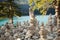 Braies lake: rock and stone man along path around the mountain lake - Dolomites