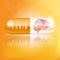 Brain in capsule orange. Medical concepts and health supplements.