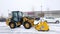 BRAINERD, MN - 19 DEC 2019: Snow removal machine for clearing Costco parking lot after winter storm. Yellow front end loader with