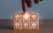brainstorming creative idea and innovation. Hand putting over wooden cube block with light bulb icon on many people together