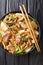 Braised Glass Noodles with Pork & Napa is a traditional Chinese dish close-up in a plate. vertical top view