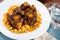 Braised oxtails with chickpeas on a white plate