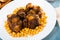 Braised oxtails with chickpeas on a white plate