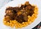 Braised oxtails with chickpeas on a white plate