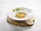 Braised Supreme Birdâ€™s Nest with Crab Roe served in a dish on wooden board side view on grey marble background