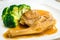 Braised whole australian abalone in savoury sauce with blanched broccoli