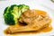 Braised whole australian abalone in savoury sauce with blanched broccoli