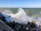 Braking waves over rocks. Stormy Black Sea landscape in Burgas bay, Bulgaria.. Splashing sea waves