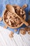 Bran flakes in a wooden bowl closeup. vertical top view