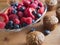 Bran muffins and berry fruit on wooden board