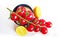 Branch of delicious fresh cherry tomatoes, lemon, quinoa over white background