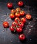 A branch of fresh tomatoes with pieces of salt.