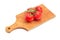 Branch of the red tomatoes on the wooden cutting board