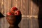 Branch of ripe red tomatoes on brown table in the kitchen. Hard light. Text space