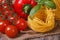 Branch of ripe tomatoes, dried pasta, fresh basil and pepper