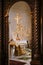 Branched gold candlestick on a table in front of a cross in the Church of St. Sava in Tivat. Montenegro