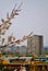 Branches of cherry blossoms on a blurred background of the railway station and residential buildings