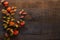 Branches with small colorful autumn leaves Spiraea Vanhouttei  and  fruit of  Physalis on the dark wooden table. Autumn composit