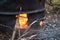 Branches and twigs being burnt in a garden incinerator.