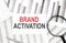 BRAND ACTIVATION text on paper with calculator,magnifier ,pen on graph background