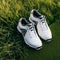 Brand new golf shoes arranged on the grass