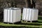 Brand new two intermediate bulk containers or IBC plastic tanks with metal cage used for water storage put on wooden pallets in