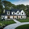 A brand white contemporary farmhouse with a dark shingled roof and black windows is seen in OAK on