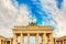 Brandenburg Gate Brandenburger Tor details in Berlin, Germany during bright day with a blue sky. Famous landmark in Berlin