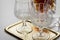 Brandy in lead crystal bottle and cognac snifter glasses on metal tray