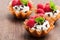 Brandy snap baskets with ice cream and berries on wooden table