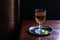 Brandy, Whiskey, or Brown Liquor in Glass in Dark Bar