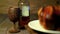 Brandy wooden glass and liquor bottle with blur roasting chicken rotating