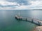 Brant Street Pier on the shore of Lake Ontario with the cloudy sky above