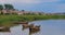 Braslau, Belarus. People Walking Near Lake Coast. Wooden Rowing Fishing Boats In Summer Evening On The Dryvyaty Lake