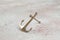 Brass anchor on concrete background