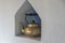 Brass antique kettle on a white brick shelf