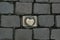 Brass Apple Emblem Embedded in Cobblestone