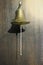 Brass Boxing Bell suspended on wooden wall.