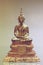 Brass Buddha statue sitting in a meditation posture