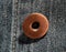 A brass button with jeans natural clean background macro photo, dark blue pattern texture, design for background with copy space