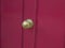 Brass central door handle on a red door