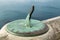 Brass or copper sun dial fixed to stone wall of castle