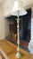 Brass floor lamp standing on a sideboard