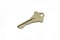 A brass house key isolated on a white background