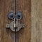 Brass lock hanging on door ring knobs