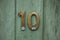 Brass number ten on door
