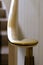 Brass railing and volute newel at bottom of staircase against white, vertical